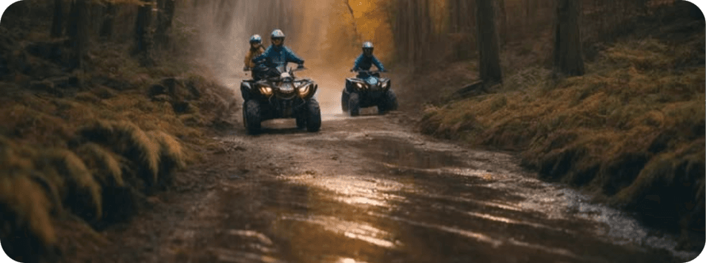 ATV riders on a forest trail